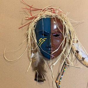 African mask with beads and feathers